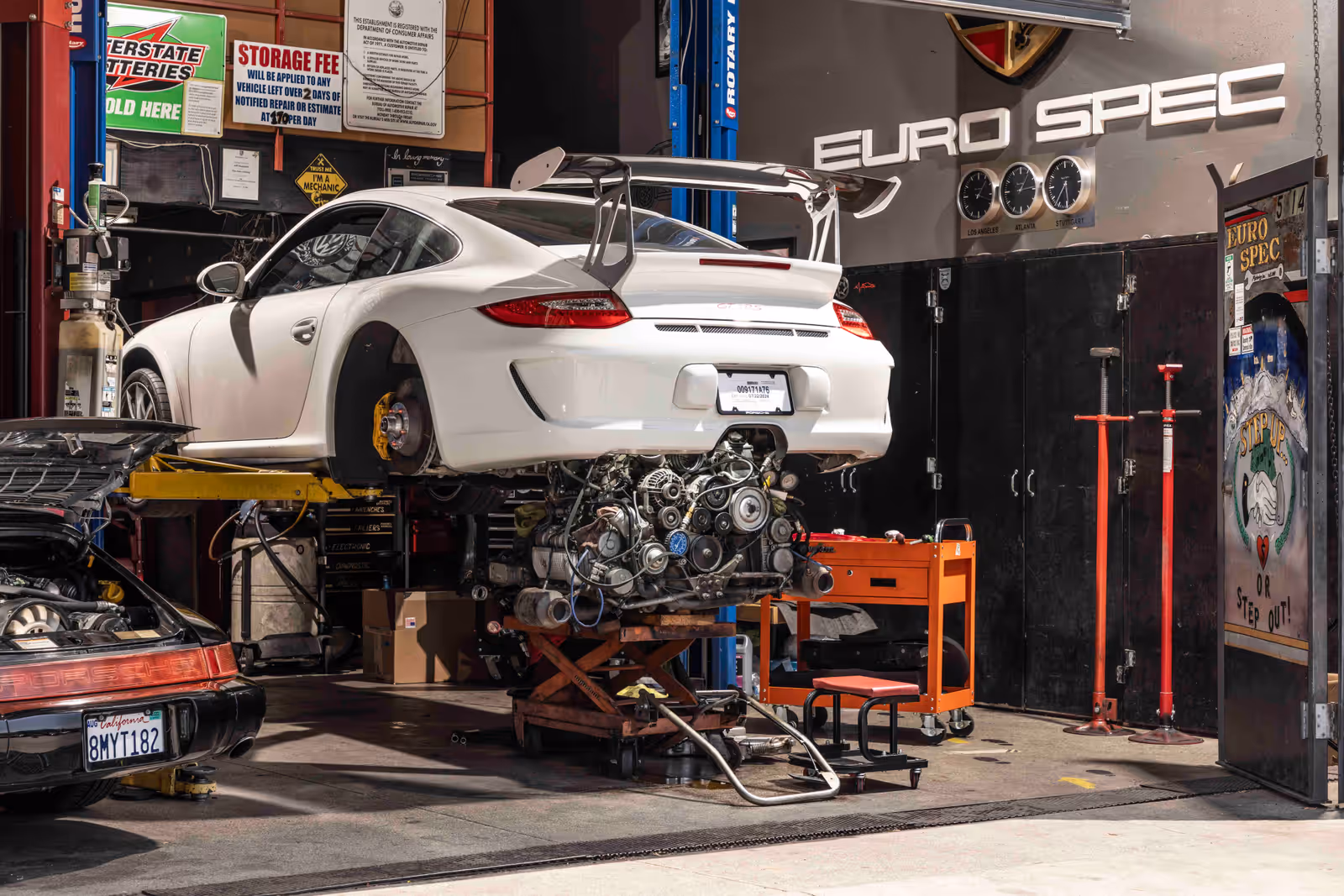 A white Porsche on a lift inside the Euro Spec Motoring workshop in Los Angeles